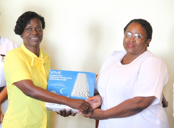 (L-r) Lornette Webbe, representative of the Simmonds family of Hanley’s Road handing over a gift of six alternating pressure systems with adjustable pumps to Acting Matron at the Alexandra Hospital Jessica Scarborough at the hospital’s conference room on July 14, 2016